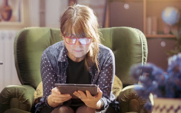 Middle aged woman using tablet for video call