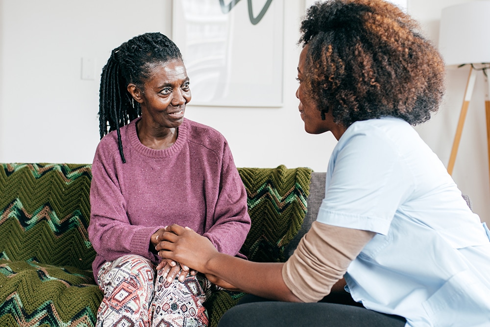 Senior lady and caregiver talking together