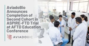 Title: AviadoBio Announces Completion of Second Cohort in ASPIRE-FTD Trial at AFTD Education Conference | Background: A group of scientists discuss their studies in a lab