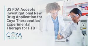 Graphic Text: US FDA Accepts Investigational New Drug Application for Coya Therapeutics’ Experimental Therapy for FTD | Background: A pair of female scientists work in a lab setting.